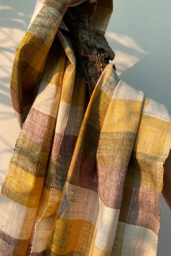 Handwoven checkered Ahimsa Eri silk stole naturally dyed with turmeric, onion skin, and Indian madder in earthy pastel tones.