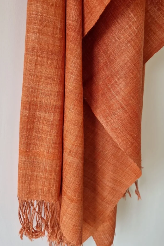 Handwoven rust-orange Ahimsa Eri silk stole naturally dyed with Indian madder, displaying soft texture and artisanal weave.