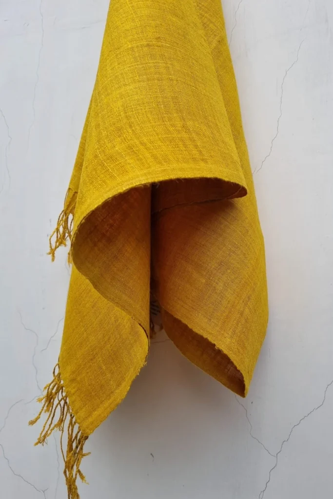 Handwoven Ahimsa Eri silk stole in rich turmeric yellow shade by Yarn Glory, showcasing natural texture and soft drape.