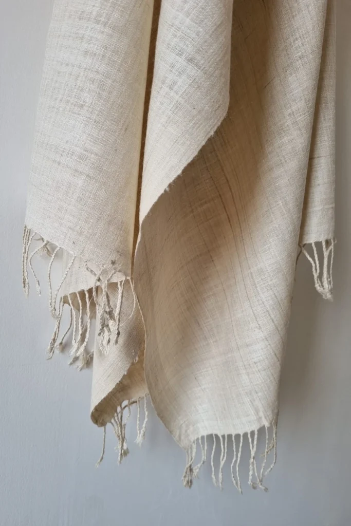 Handwoven natural off-white Ahimsa Eri silk stole with soft texture and delicate handcrafted fringes by Yarn Glory.