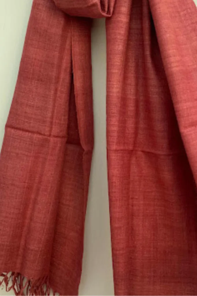 Handwoven Ahimsa Eri silk stole naturally dyed with sappan wood, featuring rich rust-red tones and soft artisanal texture.